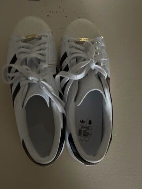 Bape White Sneakers with Black Stripes and Gold Tongue Accents